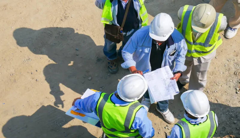 A group of design professionals and contractors on a job site. 